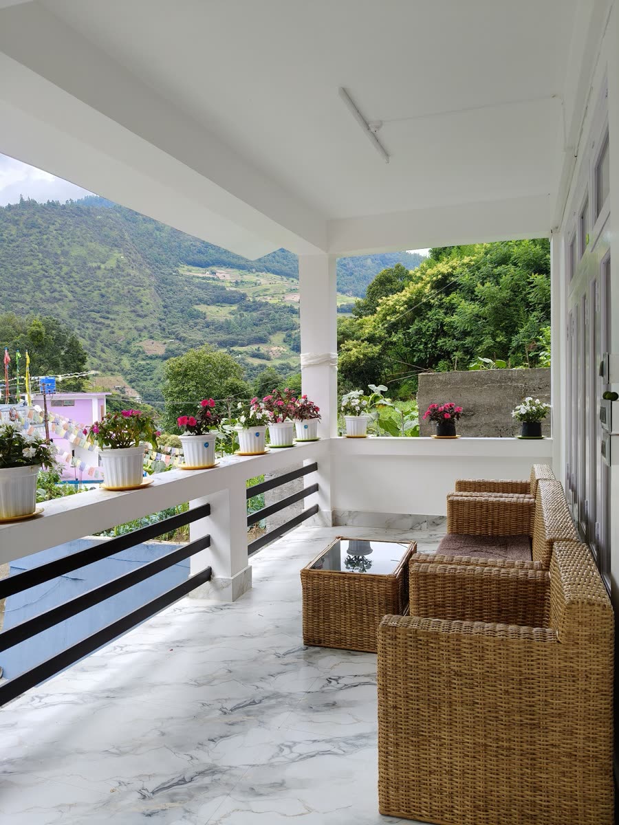 Balcony seating at Gonpapa Homestay overlooking the Dirang valley and hills